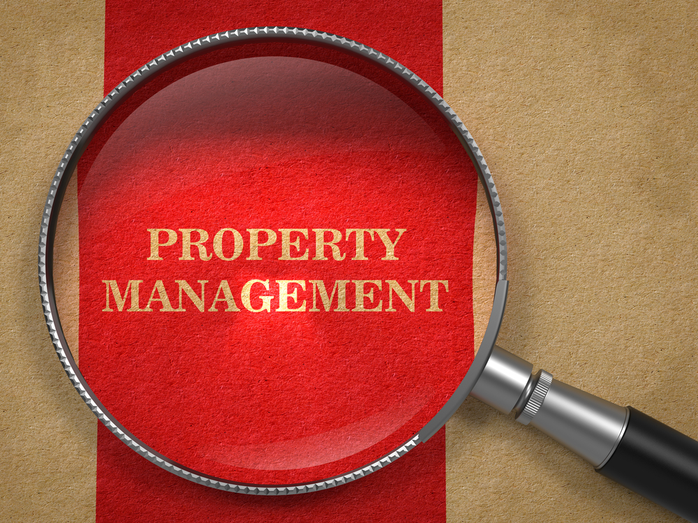 Property Management. Magnifying Glass on Old Paper with Red Vertical Line.
