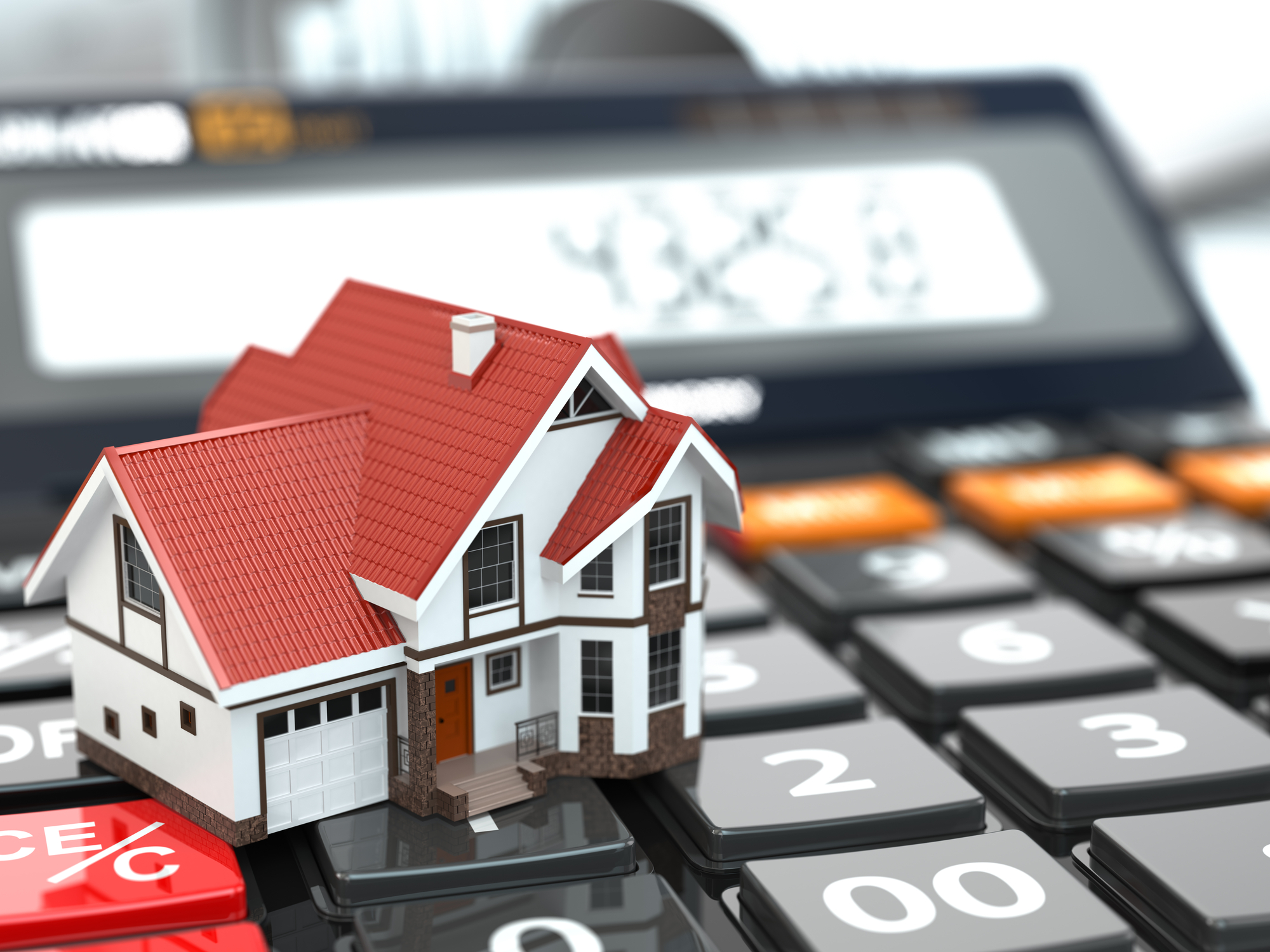 Real estate concept House on calculator Mortgage