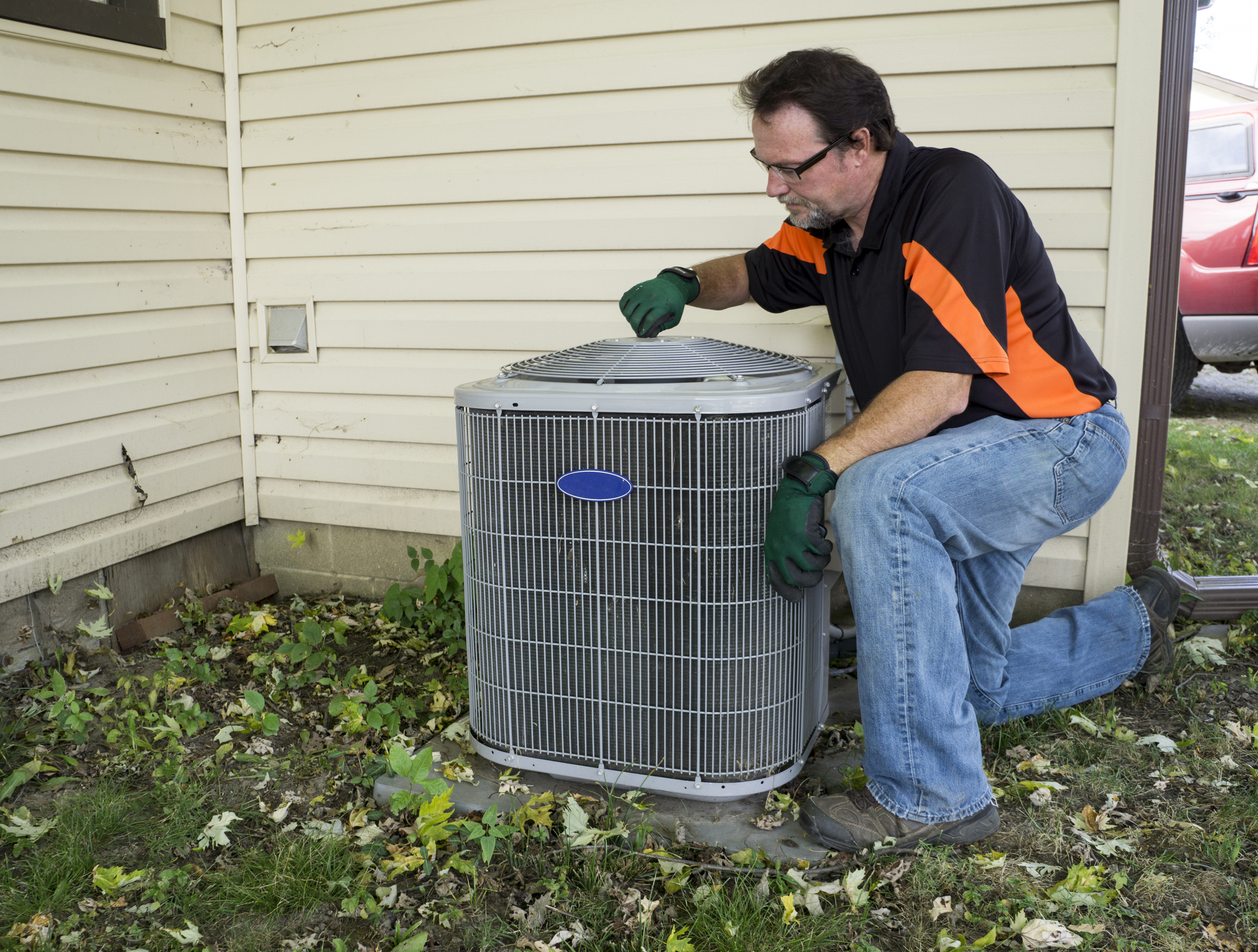 Repirman Tightening Fan Shroud On Outside Air Conditiong Unit